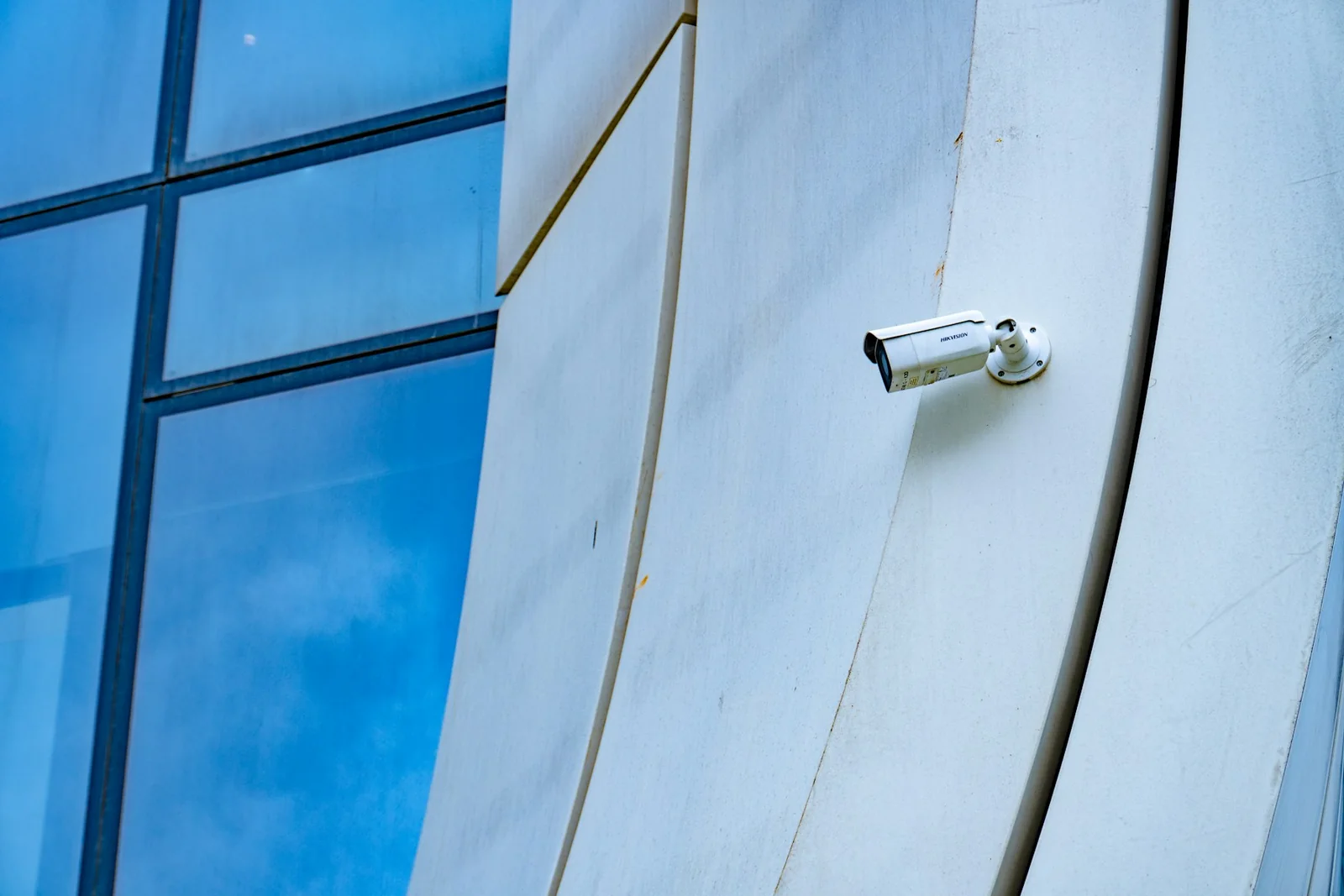 A security camera installed on modern building architecture